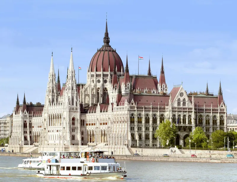Interior of the Hungarian Parliament Building showing the ornate Grand Staircase with gold detailing and red carpets during a guided tour with hungarian parliament tickets